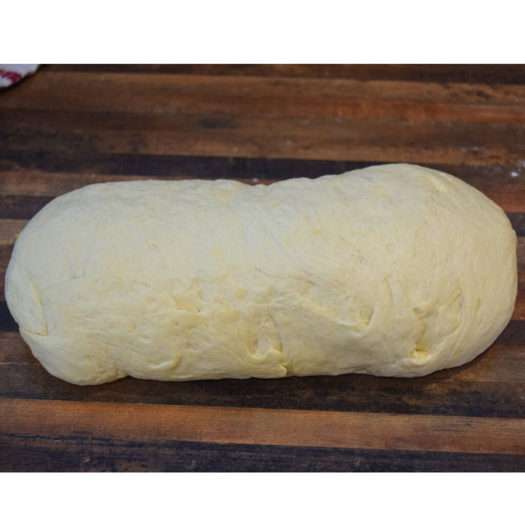 Super Simple Homemade White Bread rolled and shaped dough before going into pan.