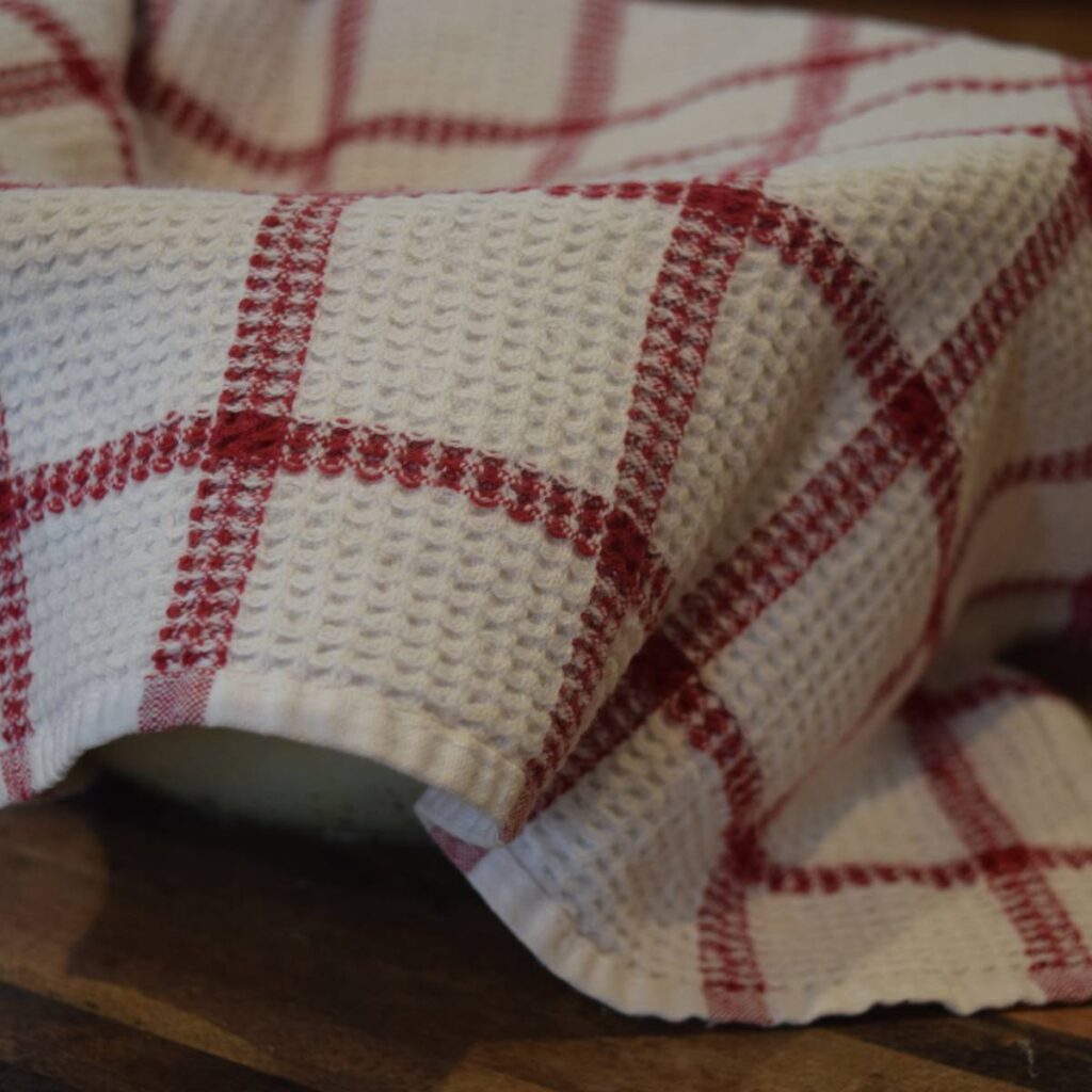 Super Simple Cheesy Buns Dough Ball Rising in Bowl Covered By a Dishtowel