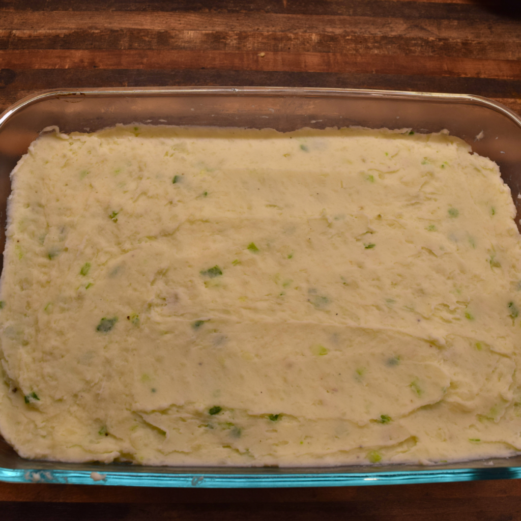 Sour Cream Potato Casserole in a dish ready for breadcrumb topping